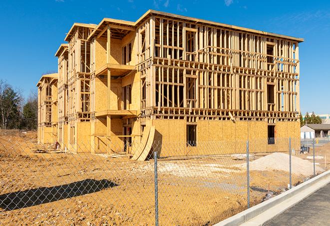 a close-up of temporary chain link fences enclosing a construction site, signaling progress in the project's development in Lowell, OR